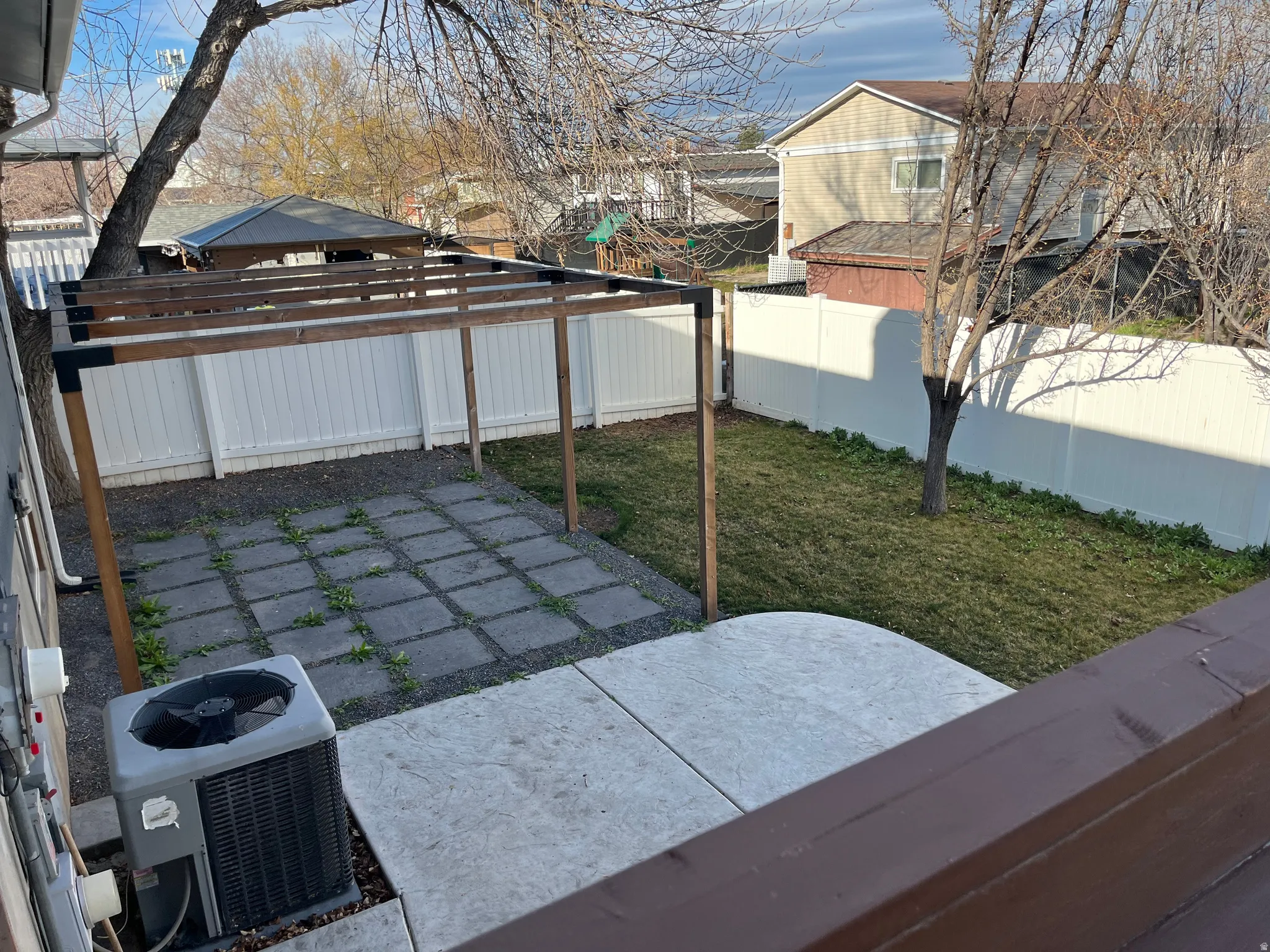 Fenced backyard with a patio area and a residential view