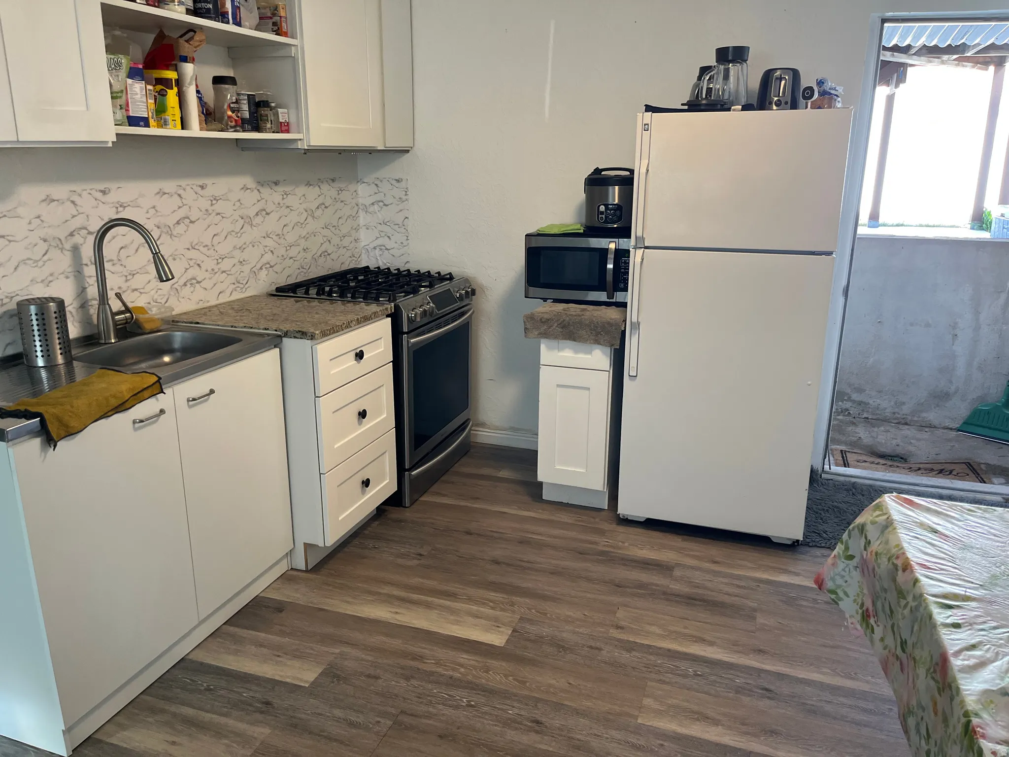 Kitchen with dark countertops and white cabinets