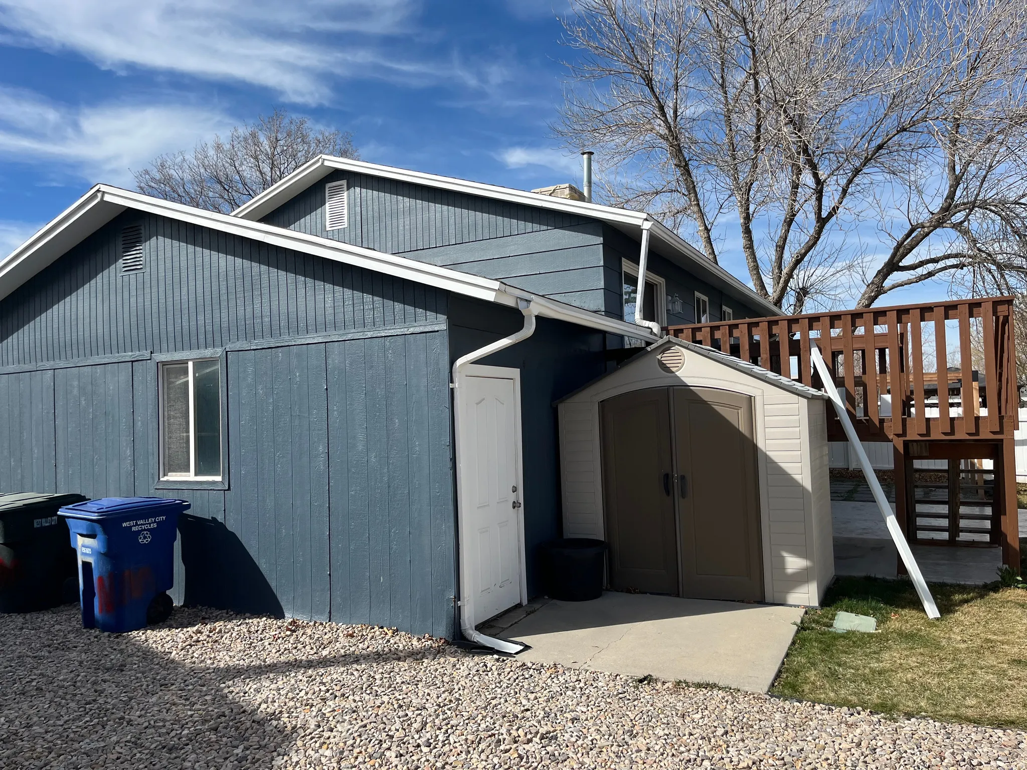 View of side of home featuring a shed