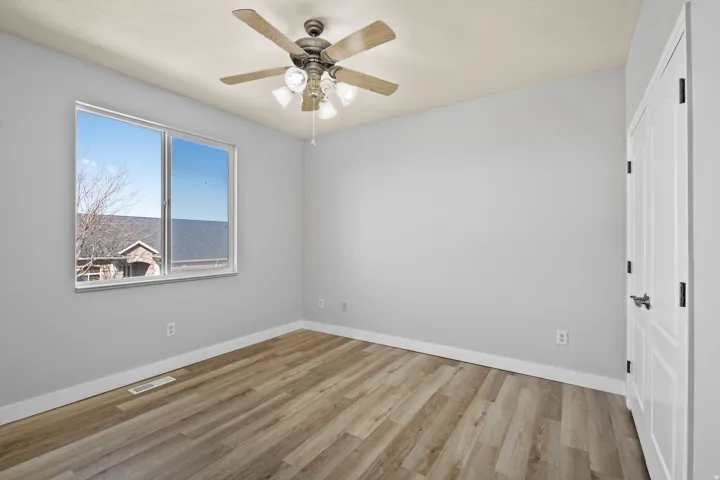 Bedroom with light wood-style floors and ceiling fan
