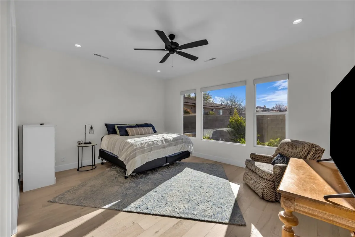 Bedroom featuring light wood-type flooring, a ceiling fan, and recessed lighting