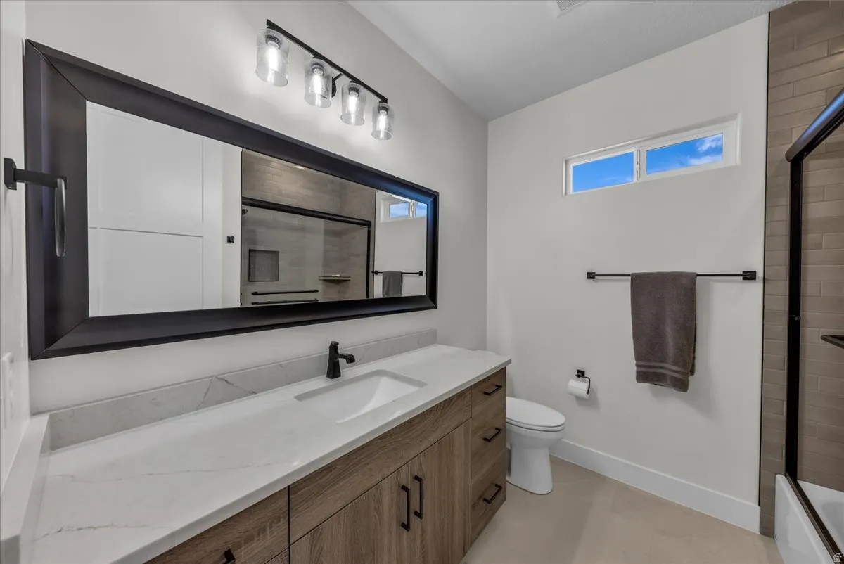 Full bathroom with vanity and light tile patterned flooring