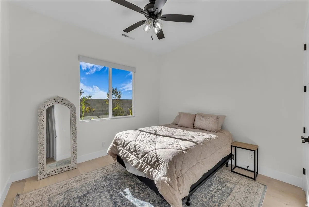 Bedroom featuring light wood-style flooring and a ceiling fan