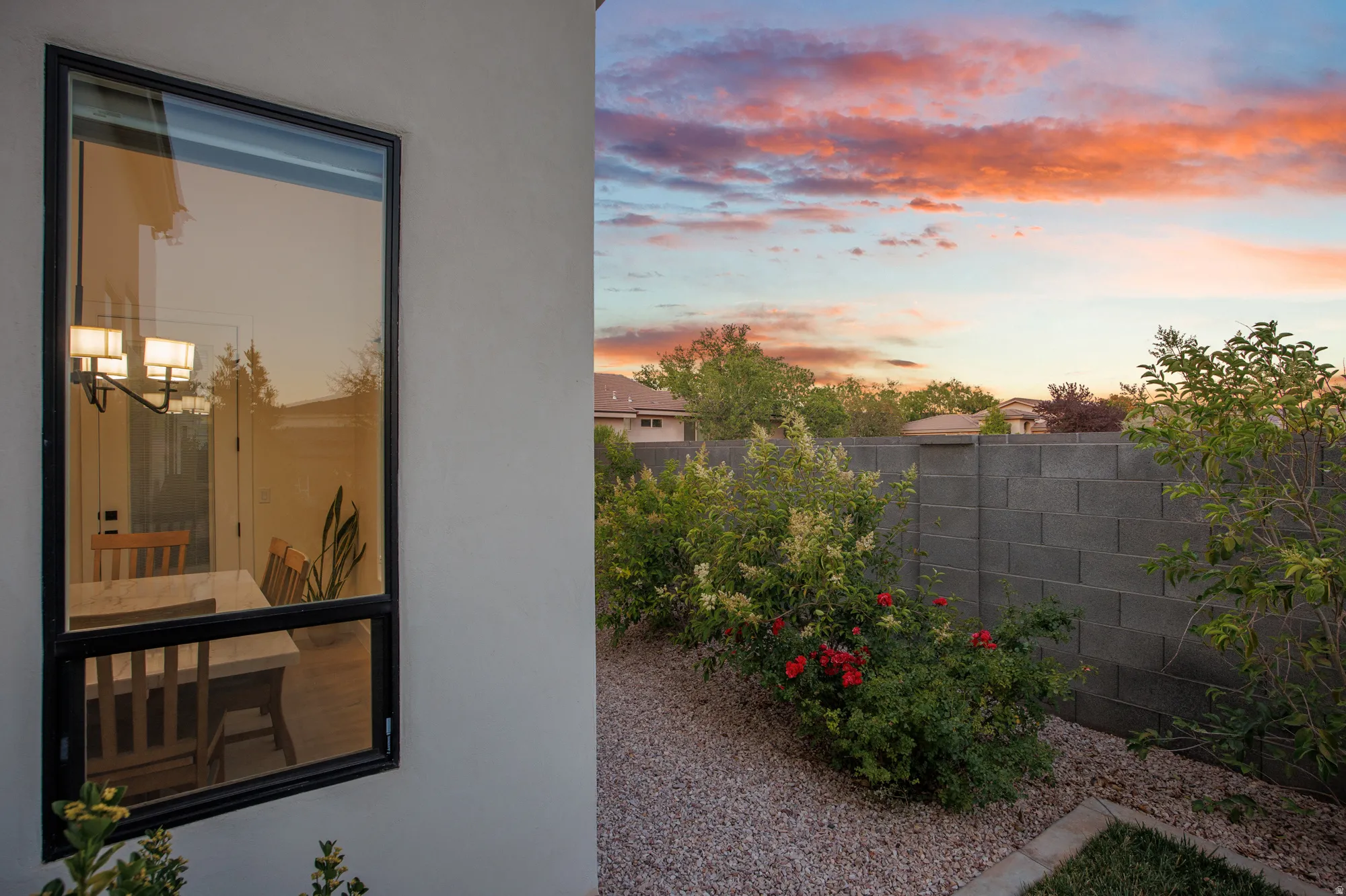 Exterior stucco finish featuring a large black-framed window