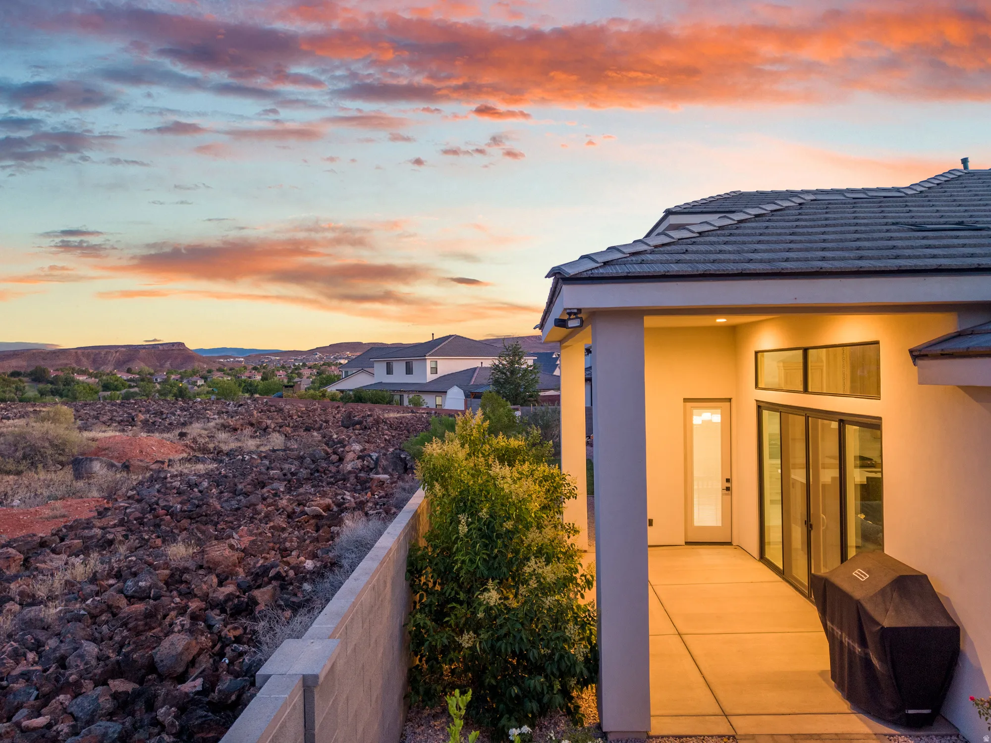 Covered patio with recessed lighting, large glass sliding doors, and a tile roof