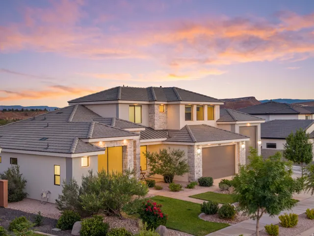 Contemporary exterior featuring mixed material facade, multi-pane windows, and a paved driveway