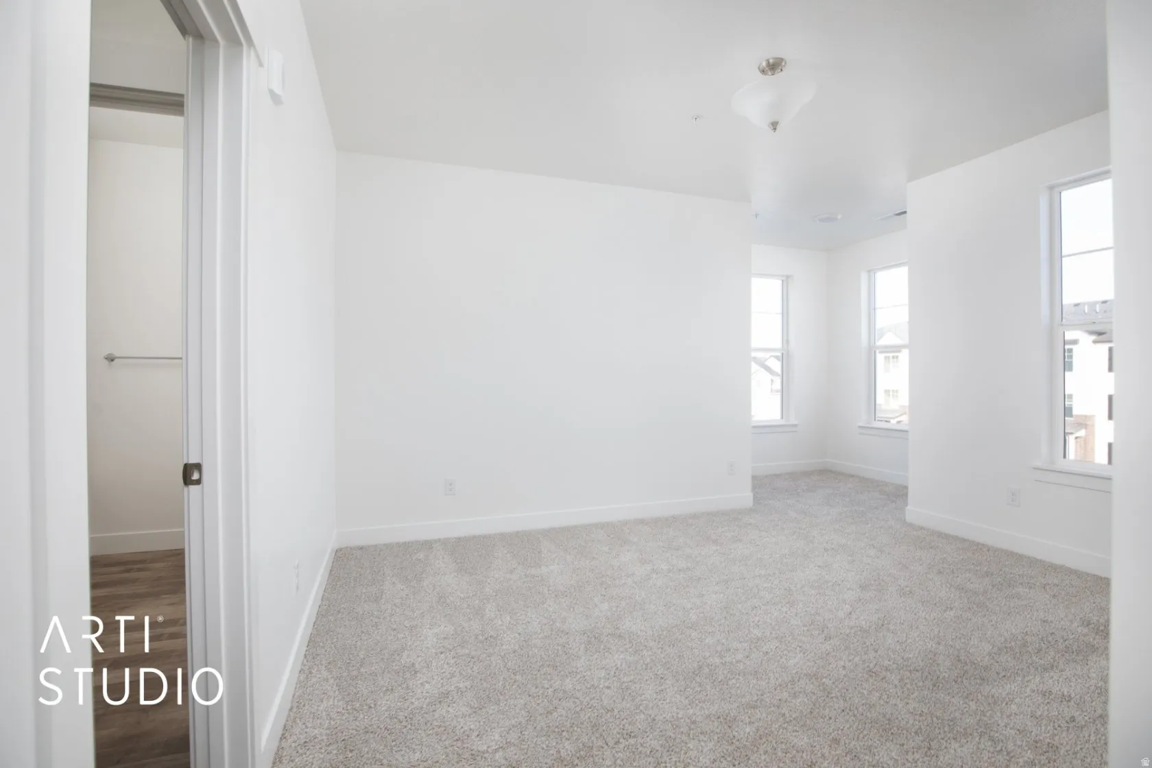 Empty room featuring carpet flooring and baseboards. Nook.