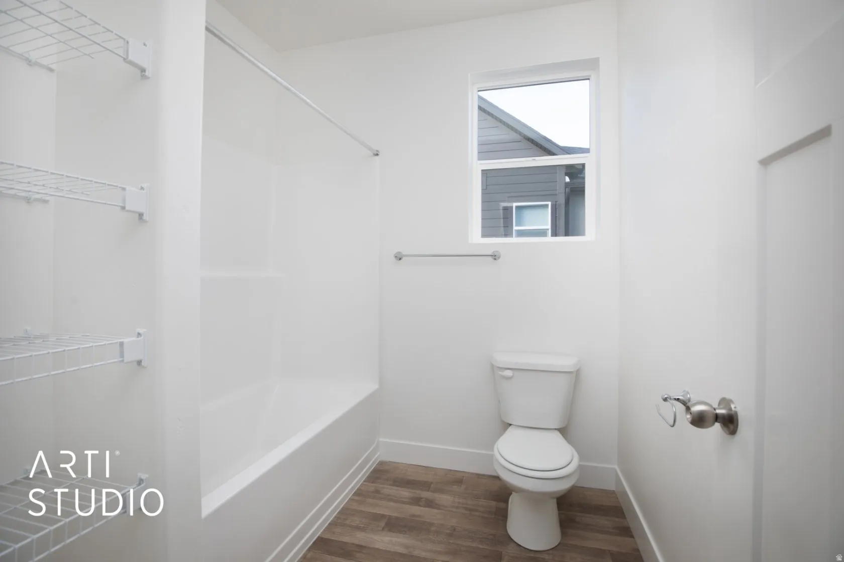 Bathroom with dark wood-type flooring and shower / bath combination