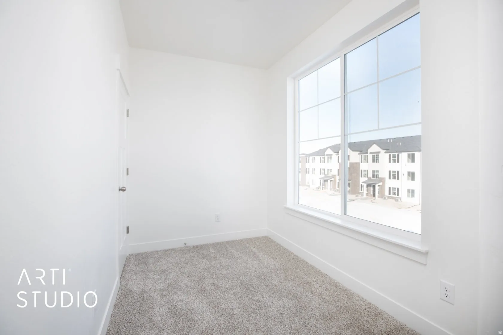 Carpeted empty nook featuring baseboards
