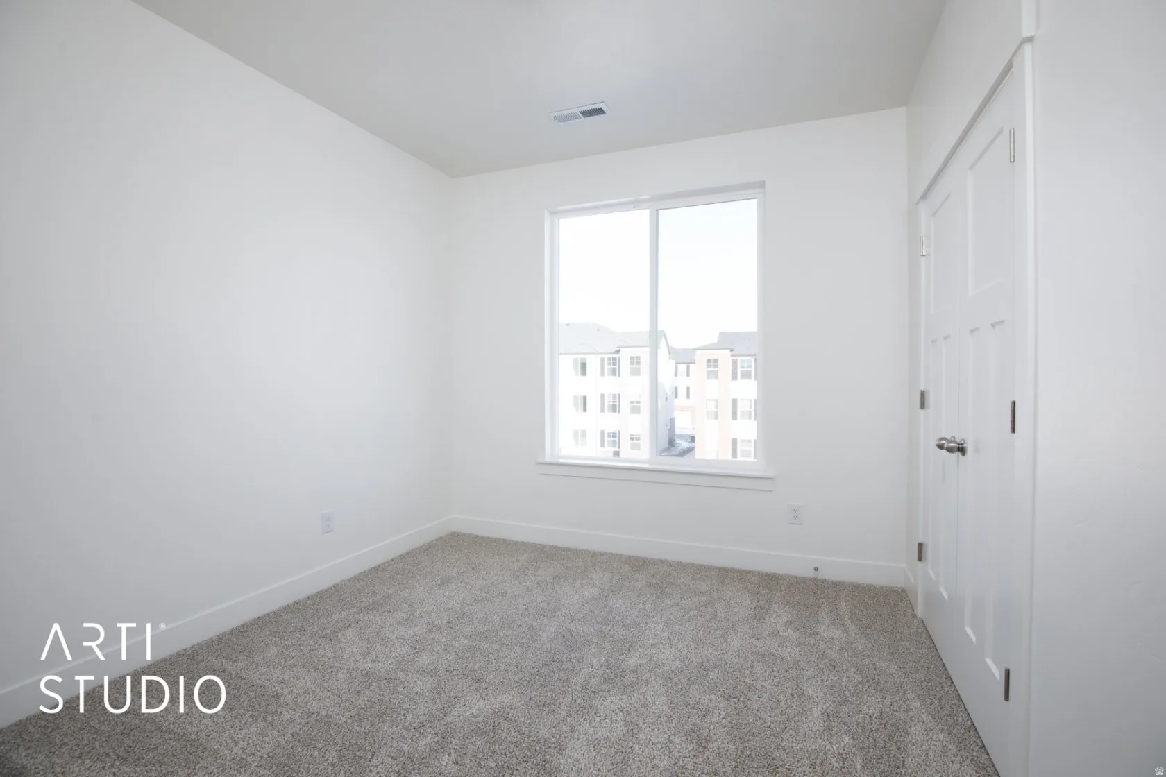 Unfurnished bedroom featuring light colored carpet and a closet