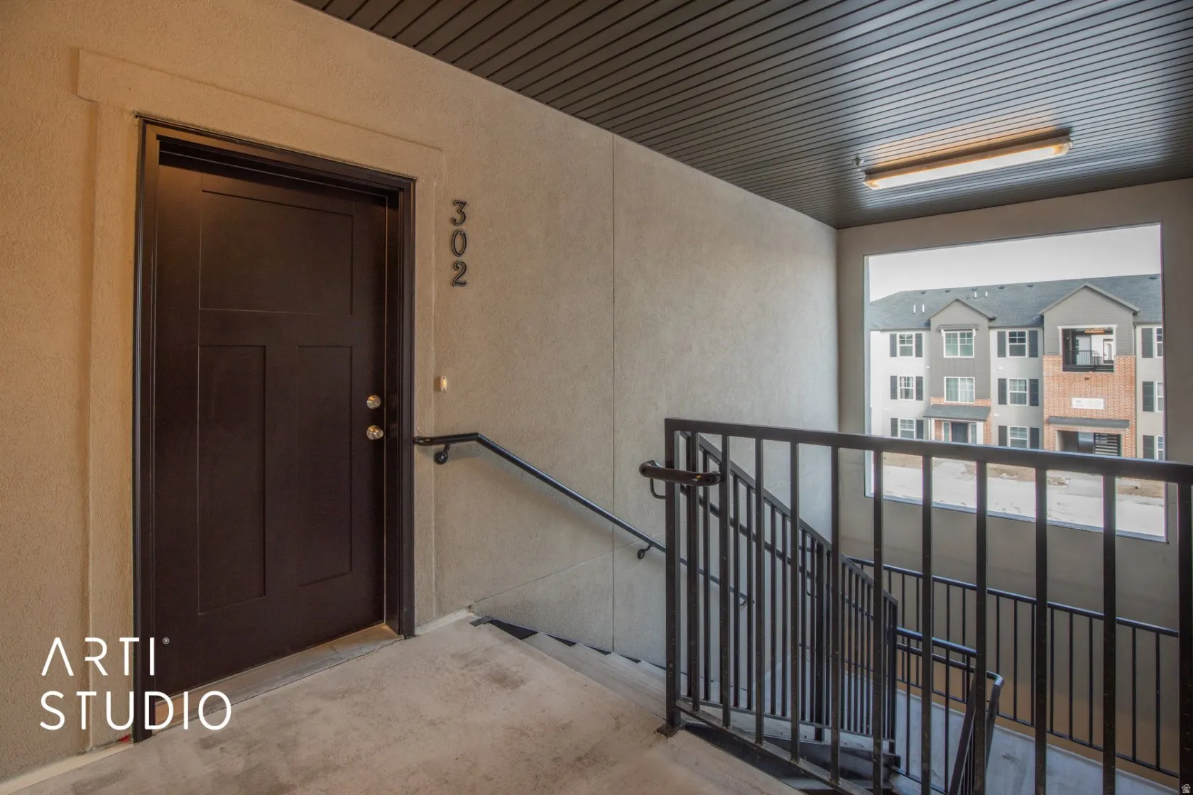 View of exterior entry featuring stucco siding