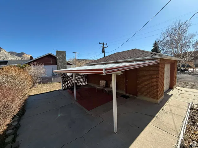 View of patio with a garage and an outdoor structure