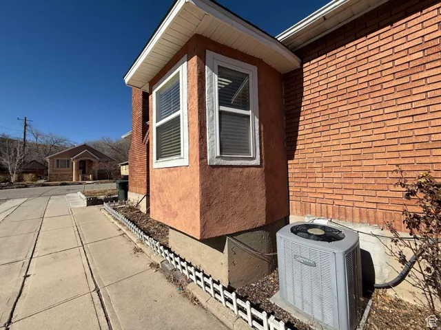 View of home's exterior with brick siding and stucco siding