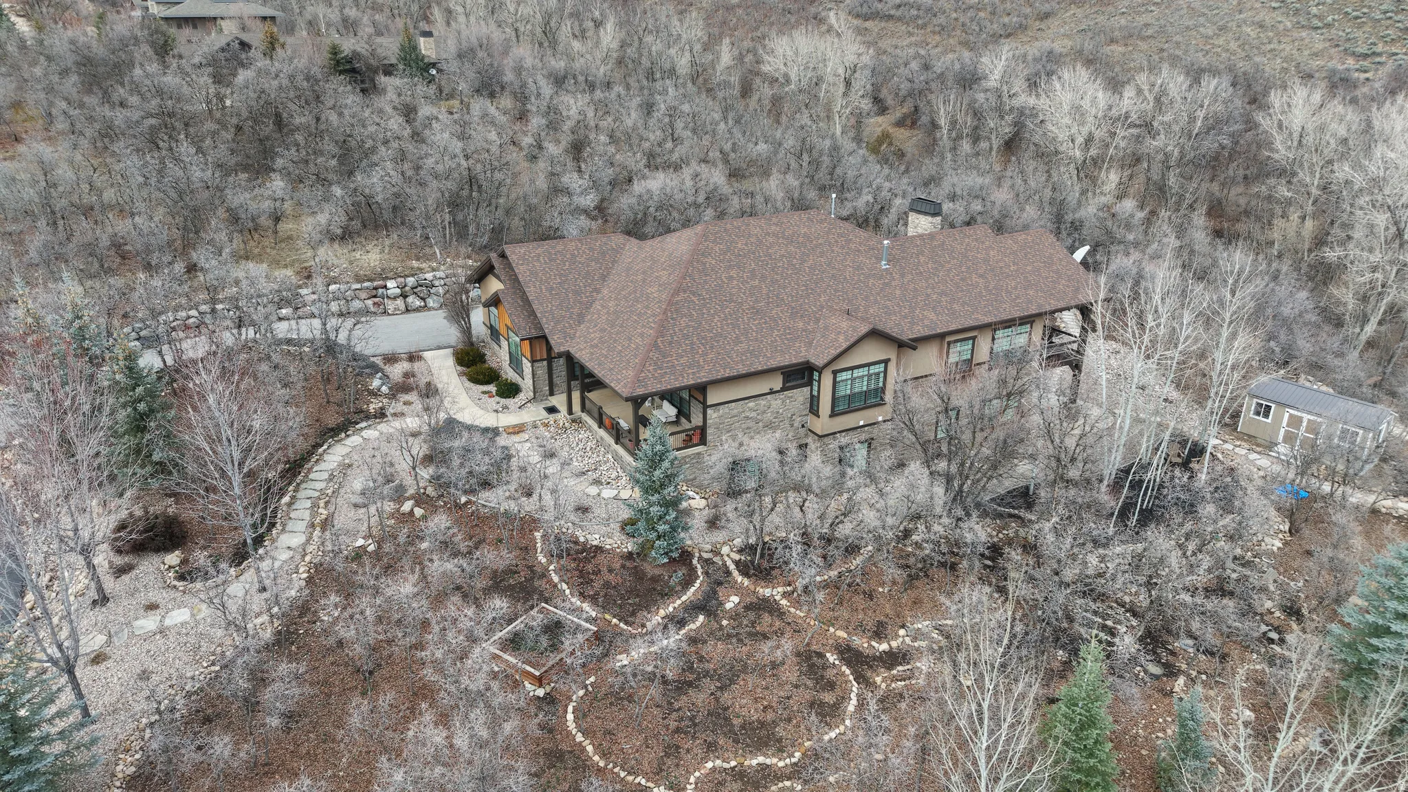 Aerial view of property and surrounding area featuring a heavily wooded area