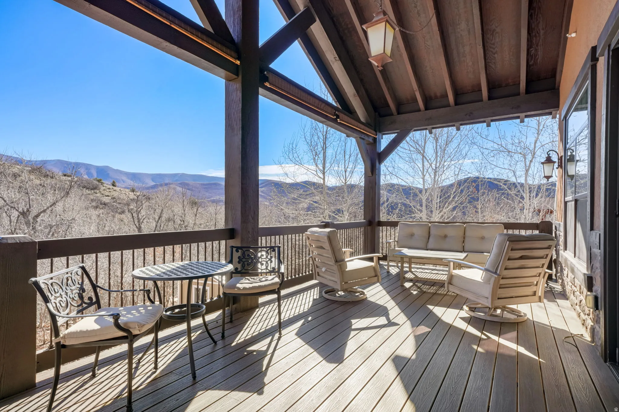 Wooden deck with outdoor seating and a mountain view