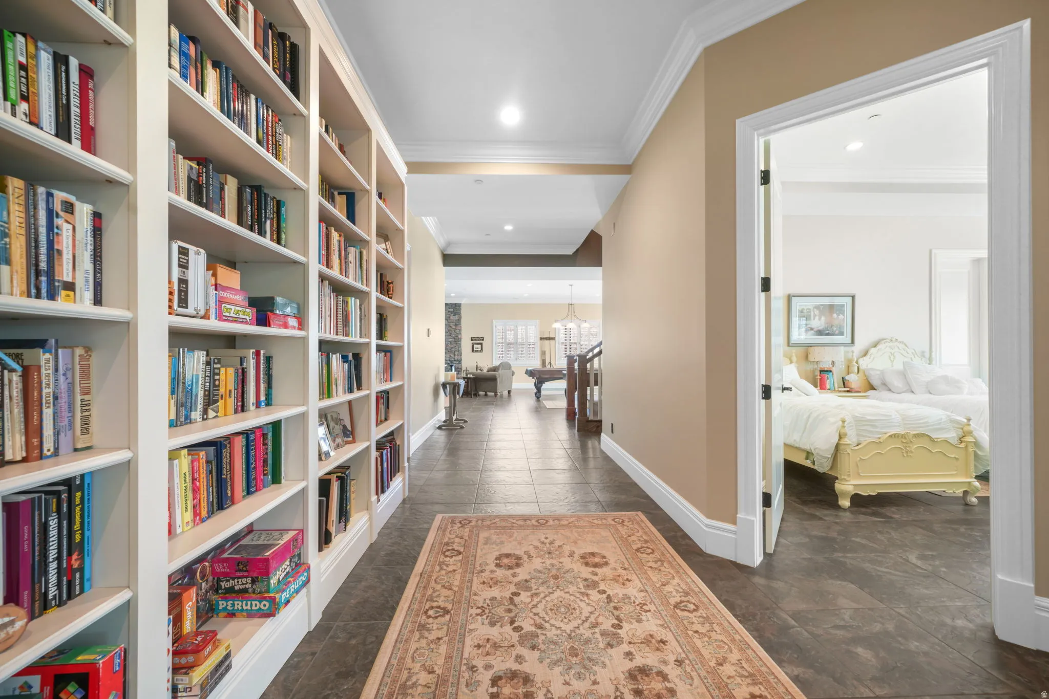 Hall featuring crown molding and a chandelier