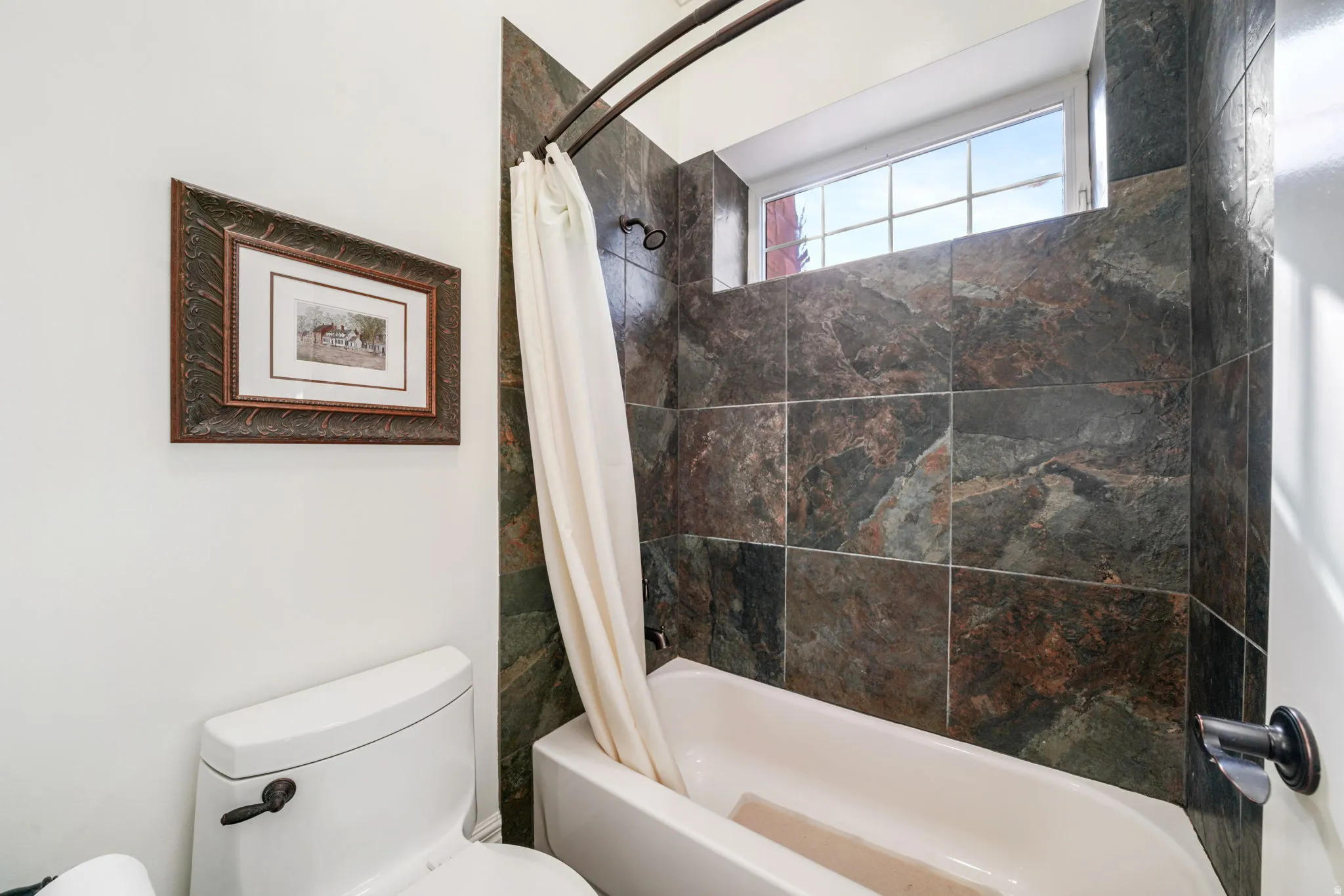 Full bathroom with toilet and shower / tub combo