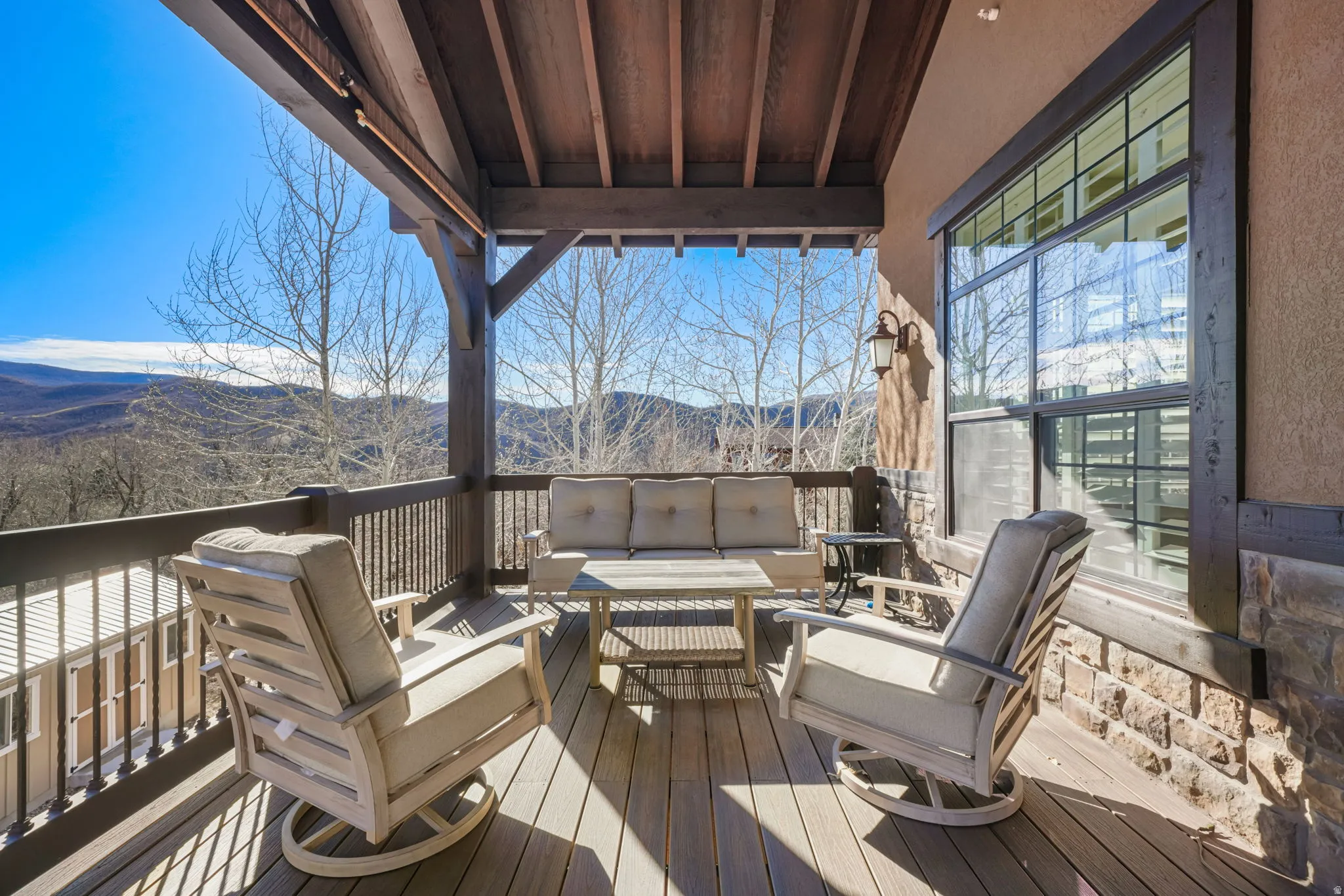 Wooden terrace featuring a mountain view and outdoor lounge area
