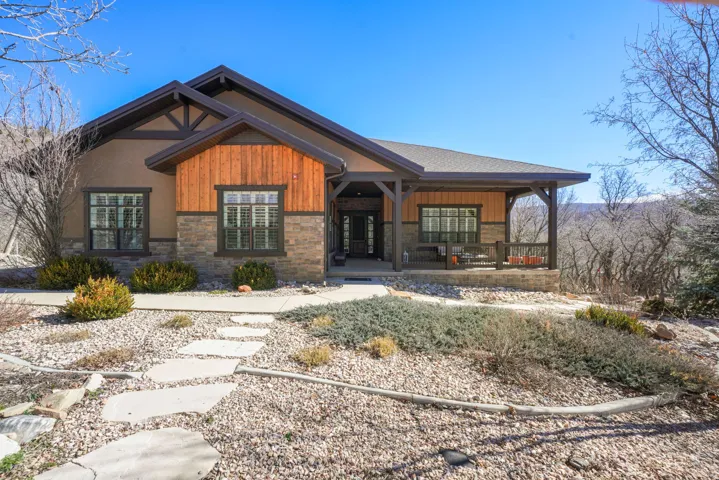Craftsman house with a porch, board and batten siding, and stone siding
