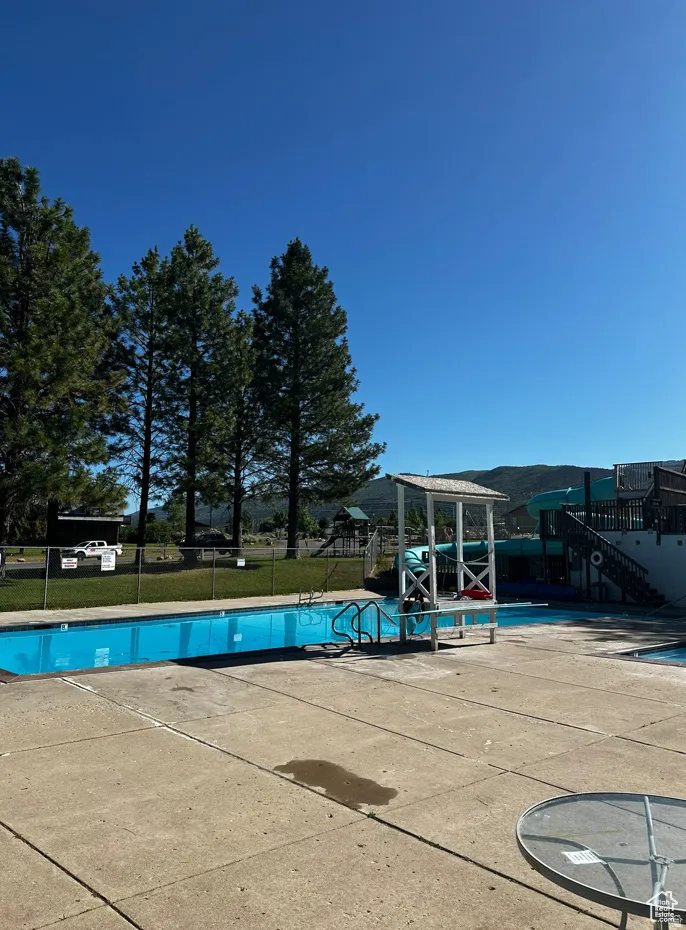 Community pool with a patio