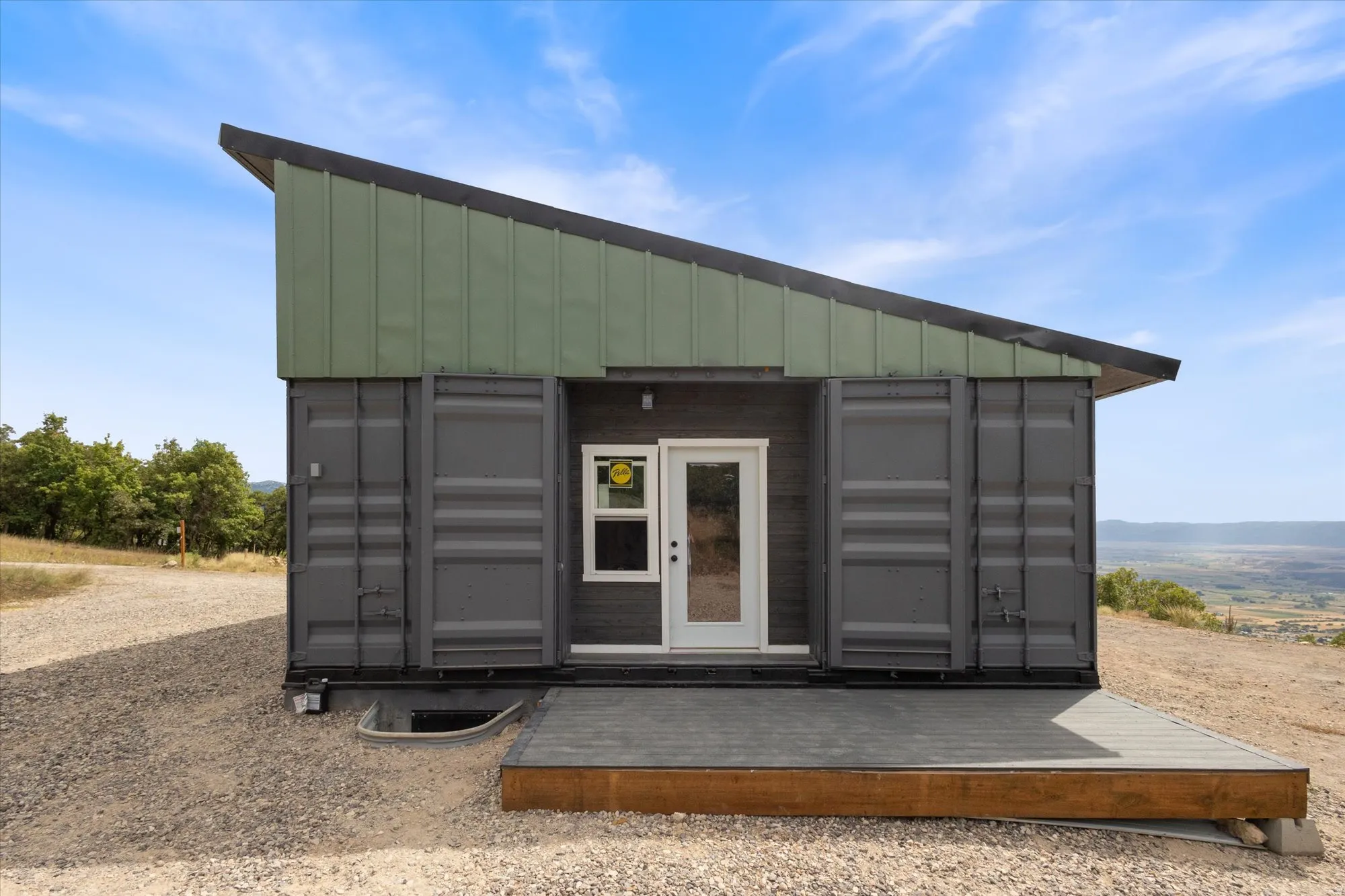 View of outbuilding featuring a sunroom