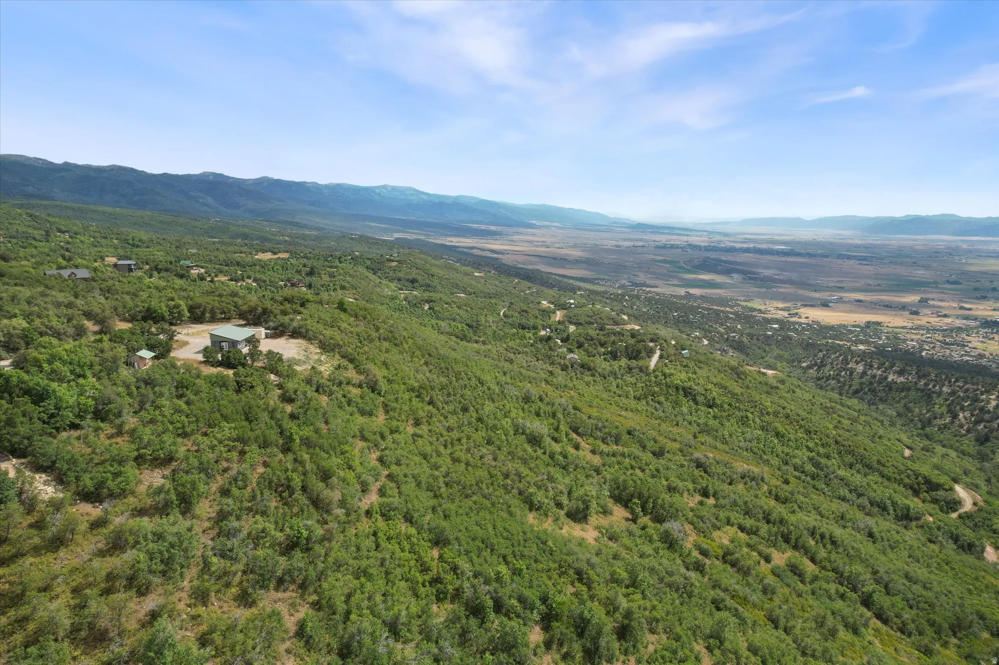 View of mountain backdrop with a heavily wooded area