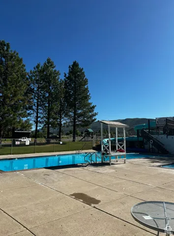 Community pool with a patio