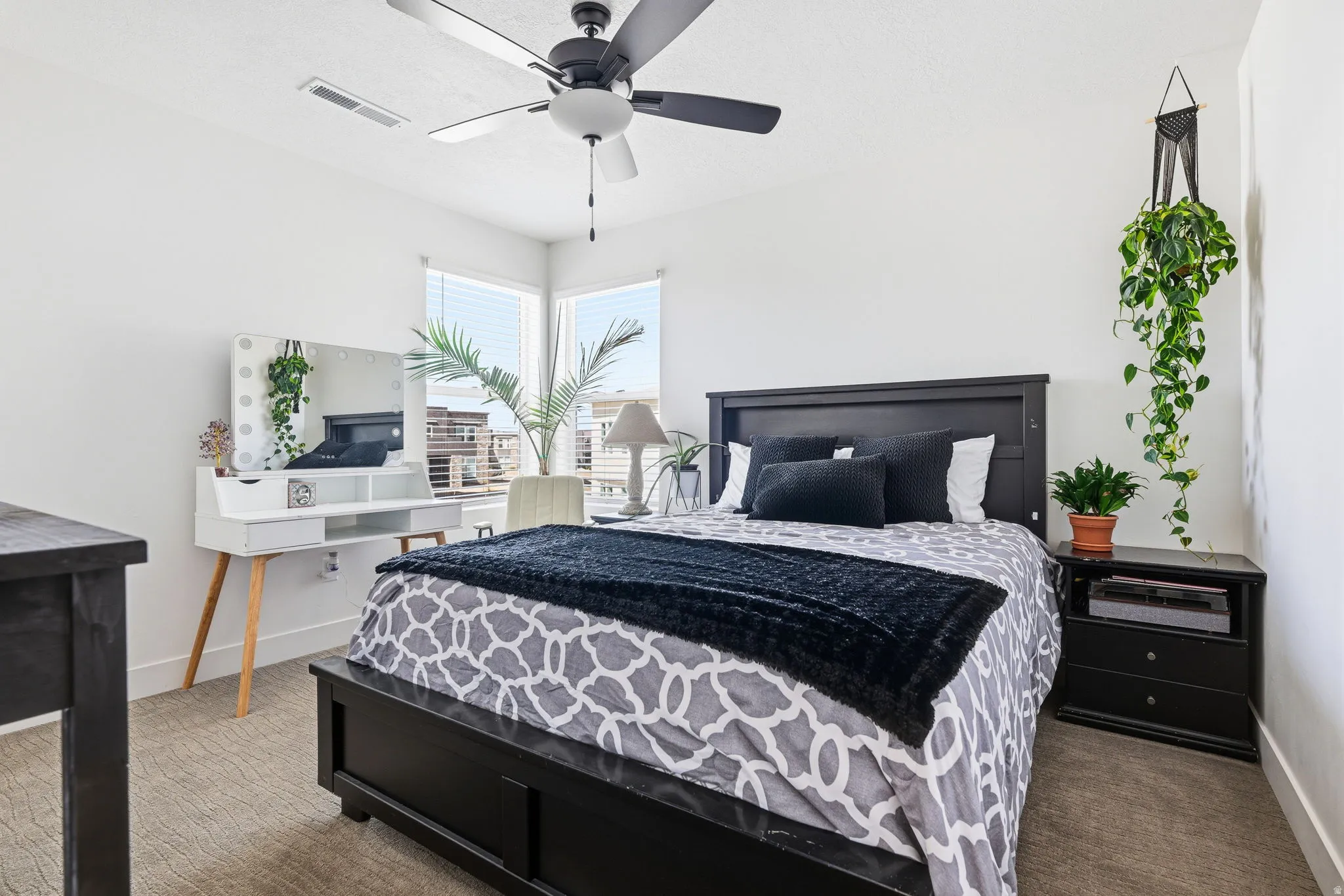 Carpeted bedroom featuring baseboards and ceiling fan