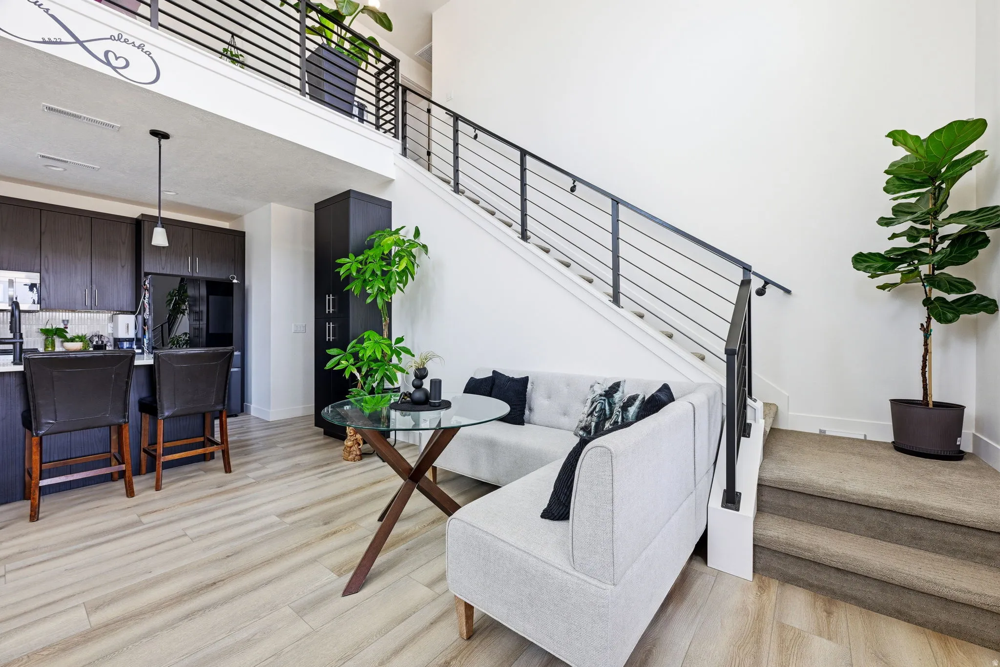 Staircase with a high ceiling and wood finished floors