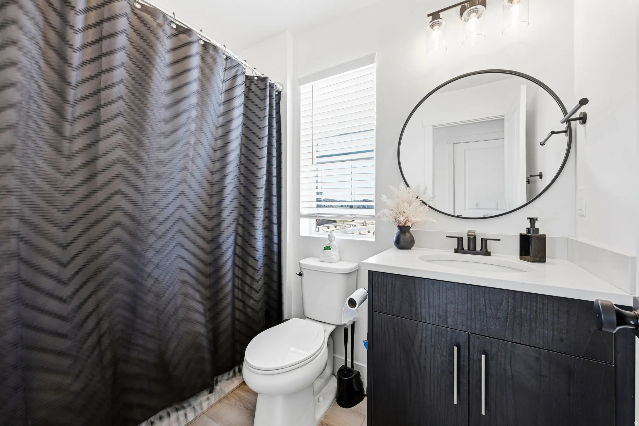 Full bathroom featuring vanity and a shower with shower curtain