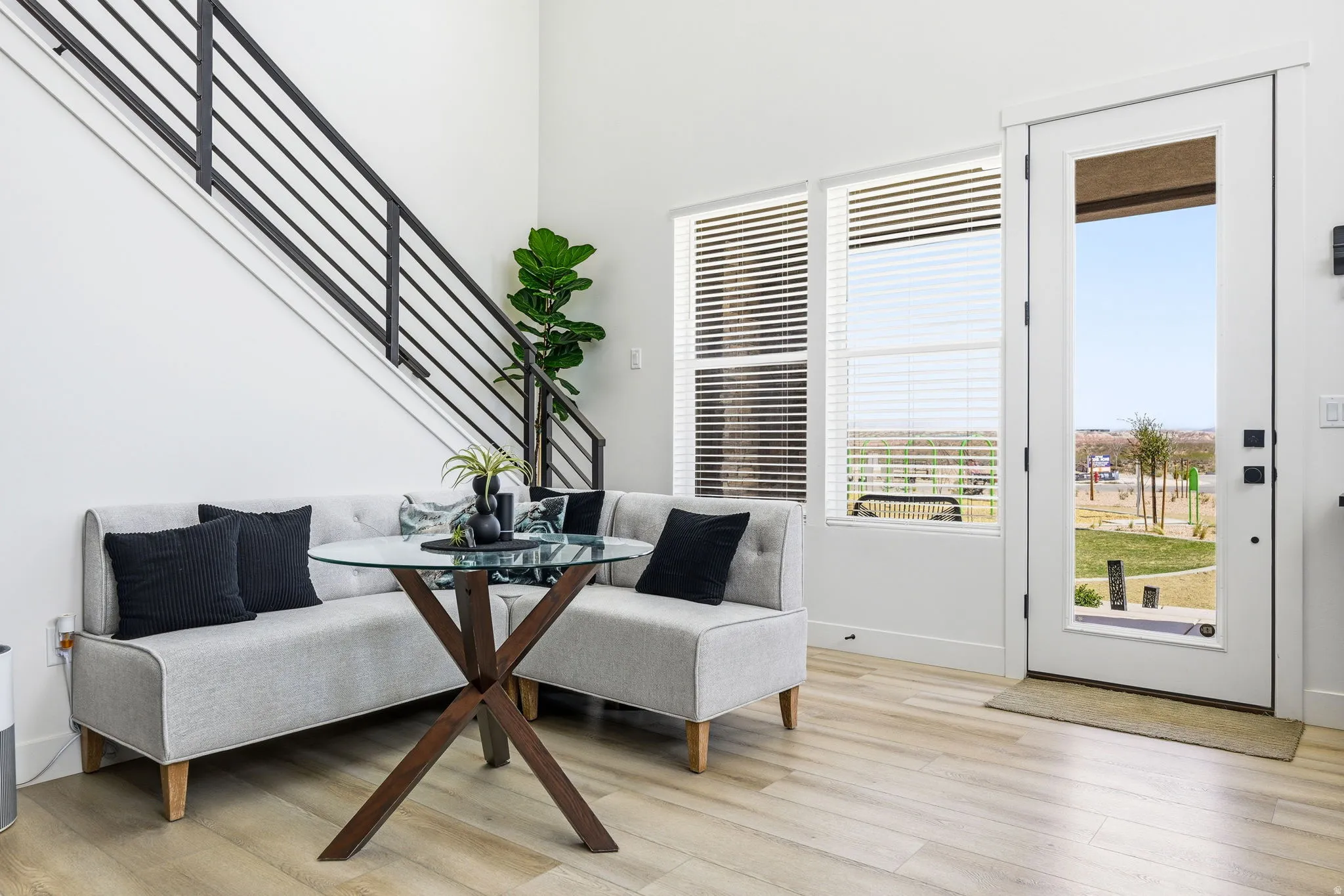 Dining space featuring light wood finished floors, a high ceiling, and breakfast area