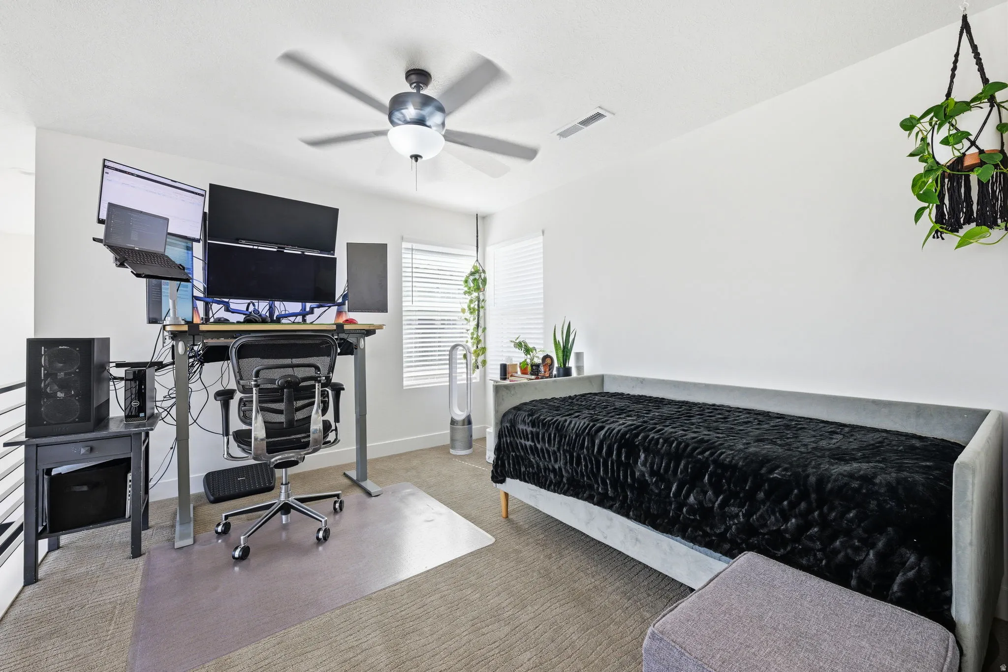 Bedroom with a desk, carpet, and a ceiling fan