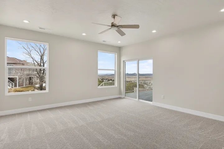 Spare room with light colored carpet, ceiling fan, and recessed lighting