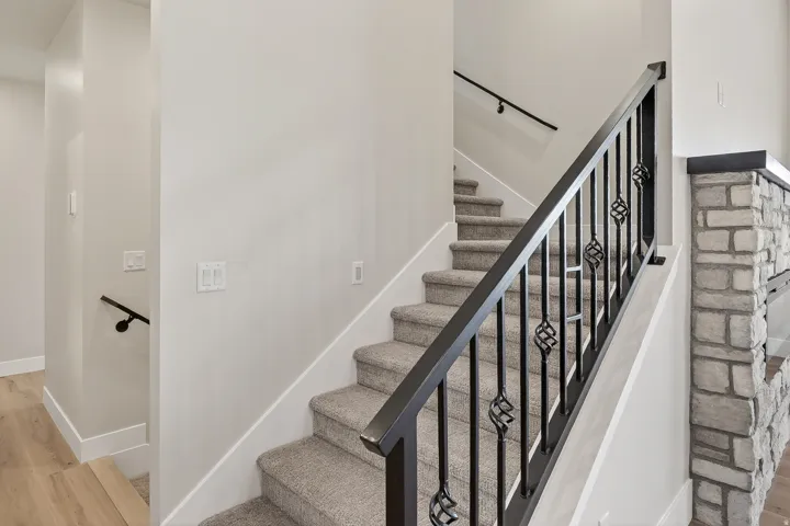 Stairs featuring wood finished floors and baseboards