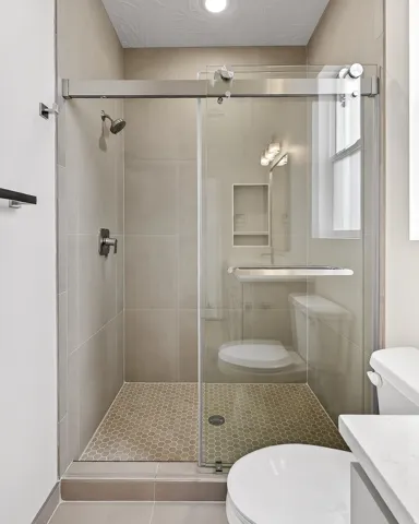 Bathroom featuring vanity, a stall shower, and a textured ceiling