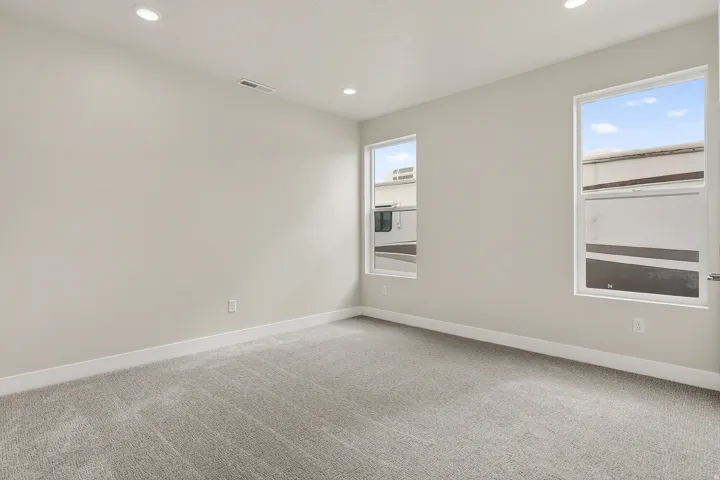 Unfurnished room featuring light carpet and recessed lighting