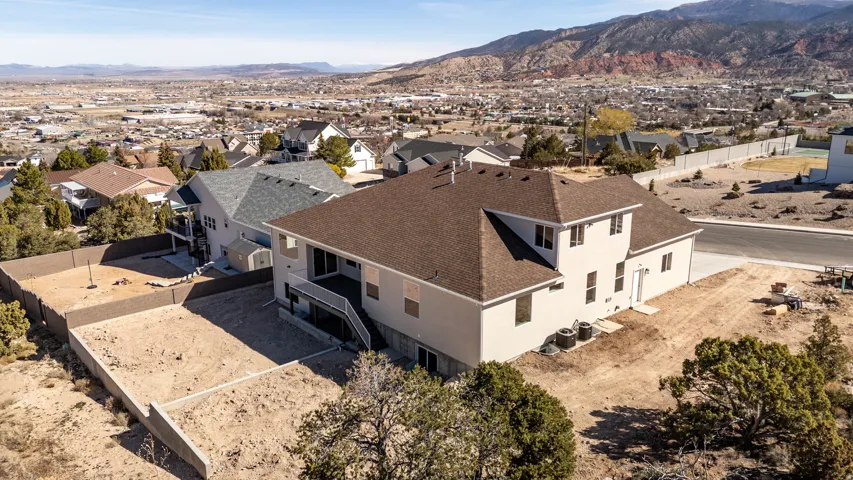 Aerial perspective of suburban area featuring a mountain backdrop