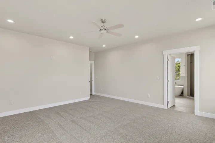 Unfurnished room featuring ceiling fan, light colored carpet, and recessed lighting