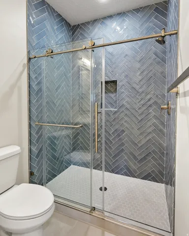 Bathroom with a stall shower and tile patterned floors