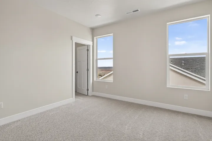 Unfurnished room featuring baseboards and light colored carpet