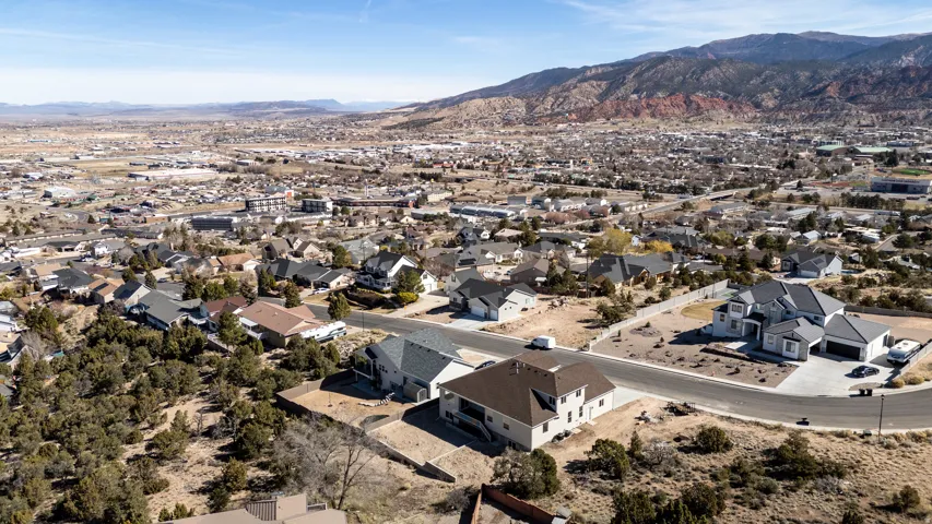 Aerial view of property's location featuring mountains and nearby suburban area