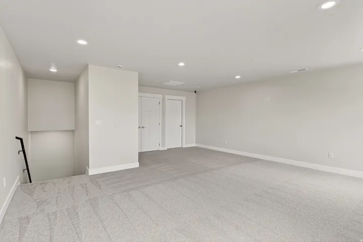 Unfurnished room with recessed lighting and light carpet