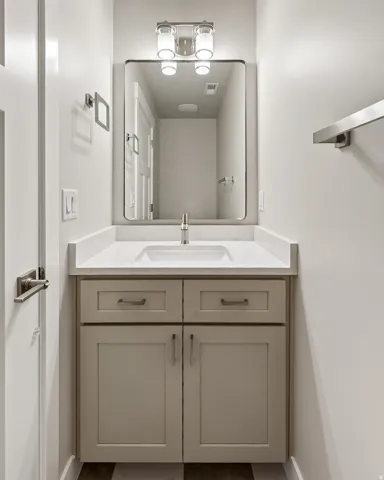 Bathroom featuring vanity and baseboards