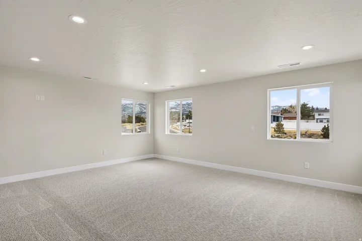 Unfurnished room featuring light colored carpet and recessed lighting