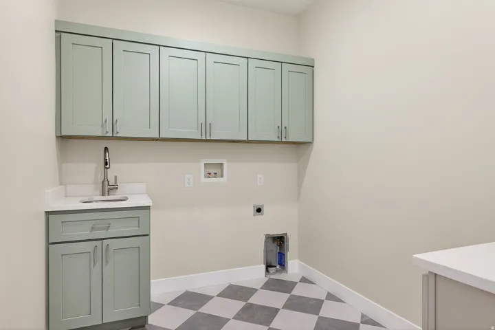 Laundry room with dark floors, cabinet space, washer hookup, and electric dryer hookup