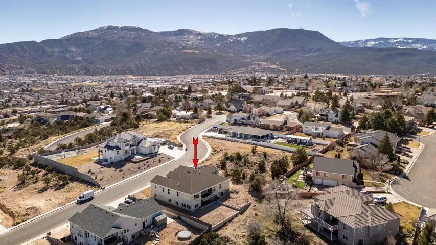 Aerial overview of property's location with mountains and nearby suburban area