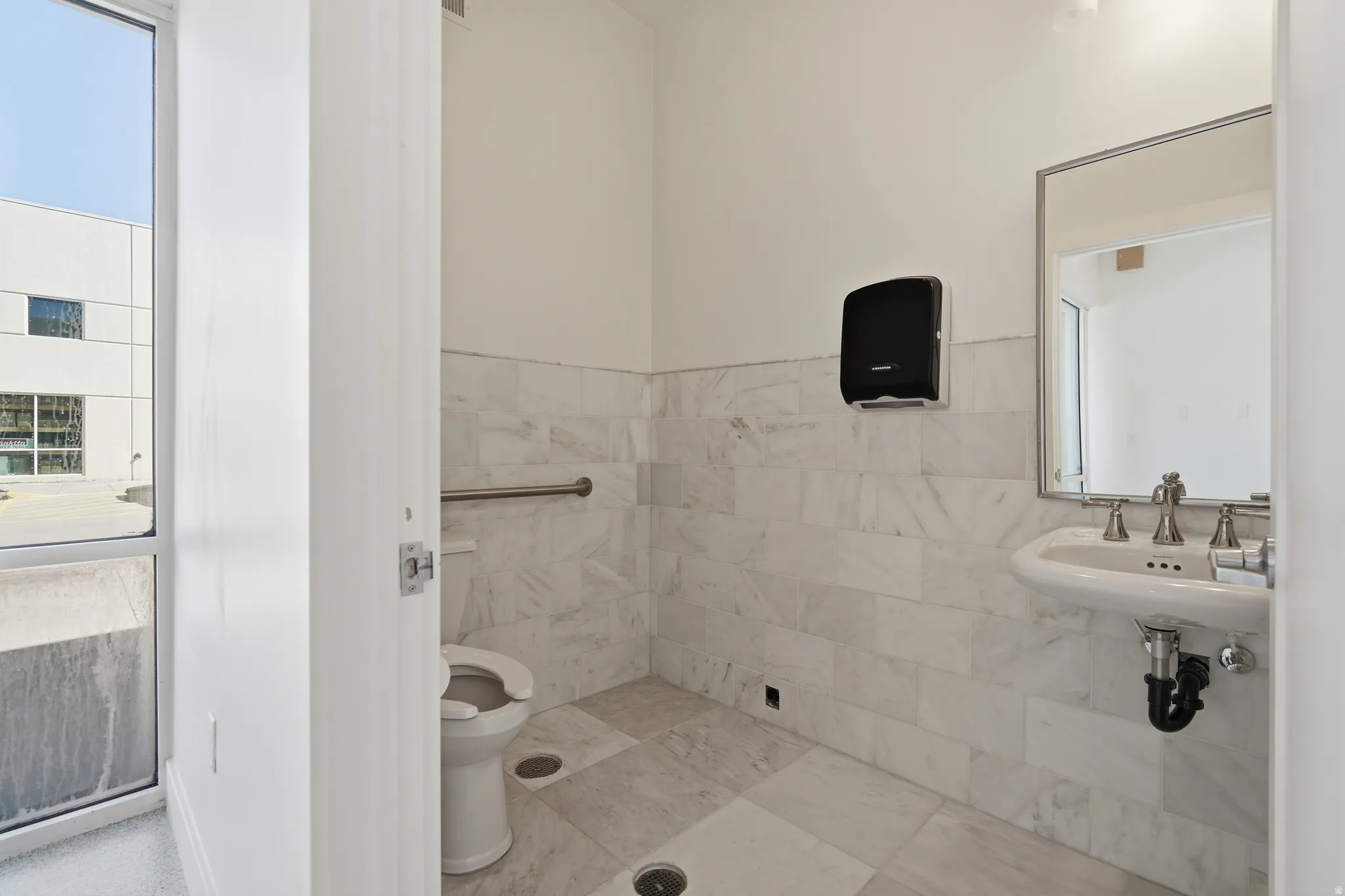 Bathroom featuring tile walls