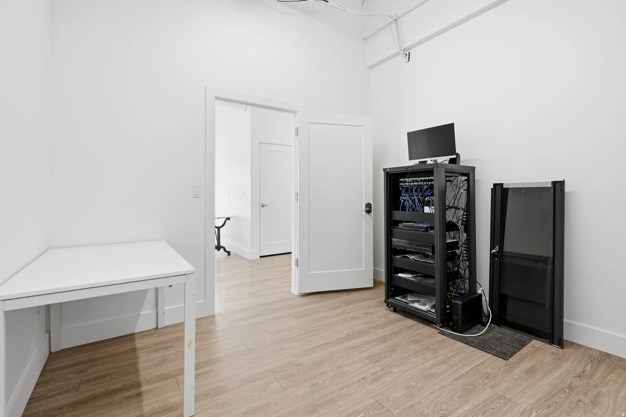 Office space featuring light wood-type flooring and baseboards