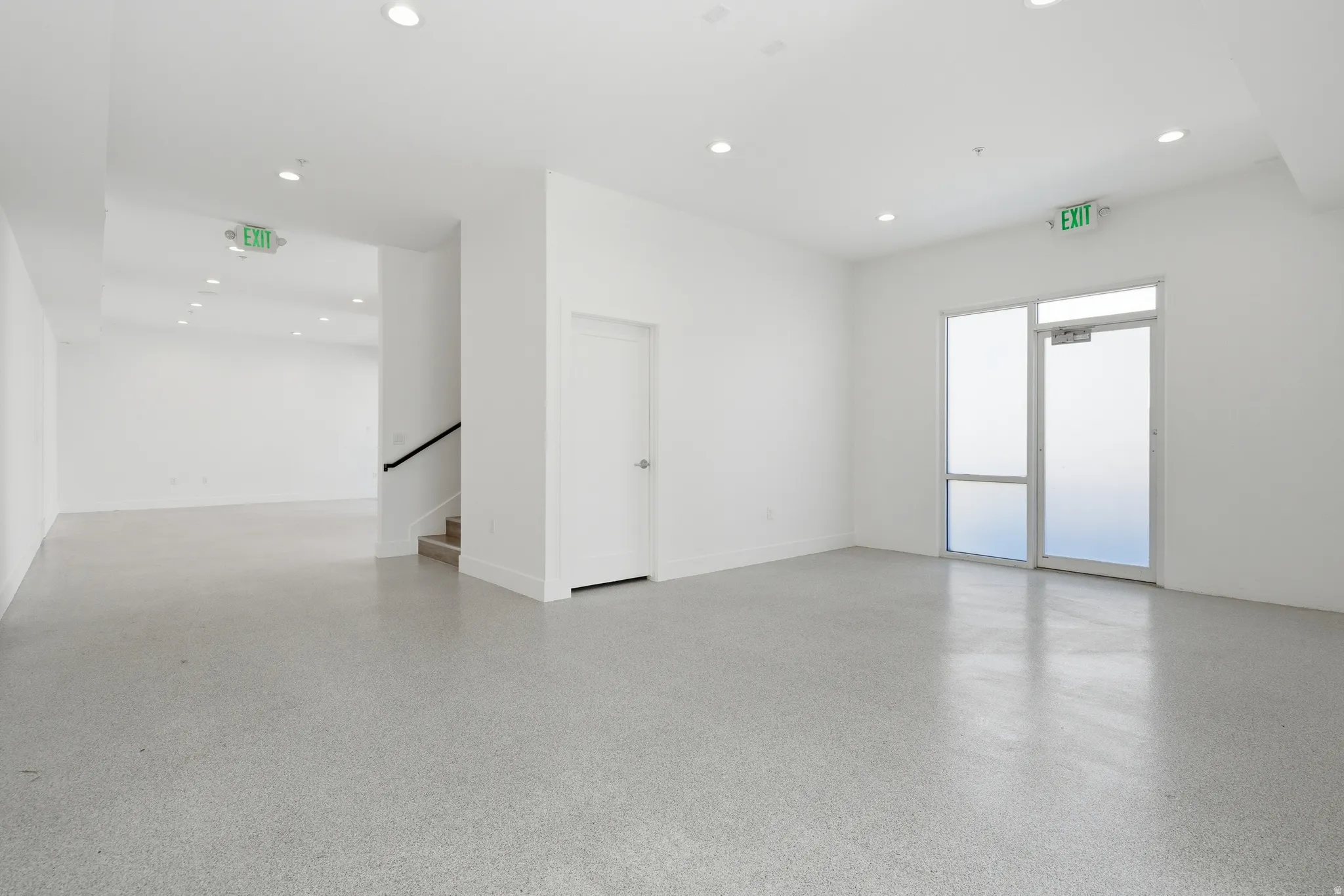 Unfurnished room featuring epoxy flooring and recessed lighting