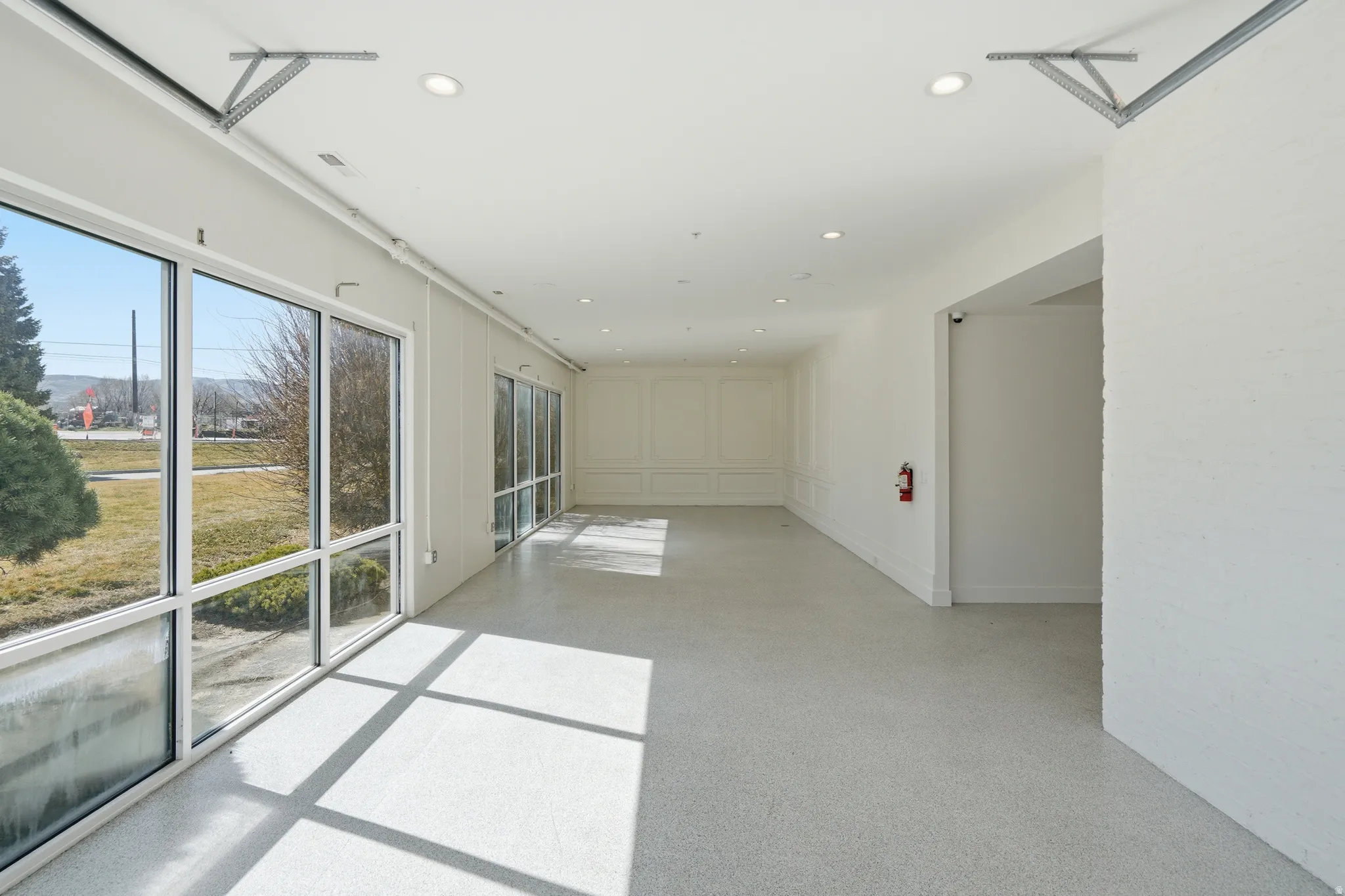 Spare room featuring recessed lighting and light epoxy flooring